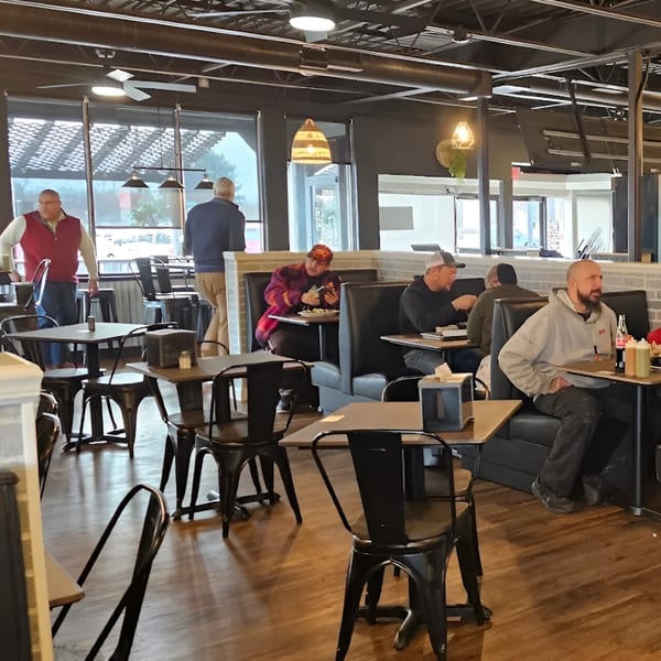 Customers dining in Cabaña Mexican Grill, with some seated at tables and others at booths.