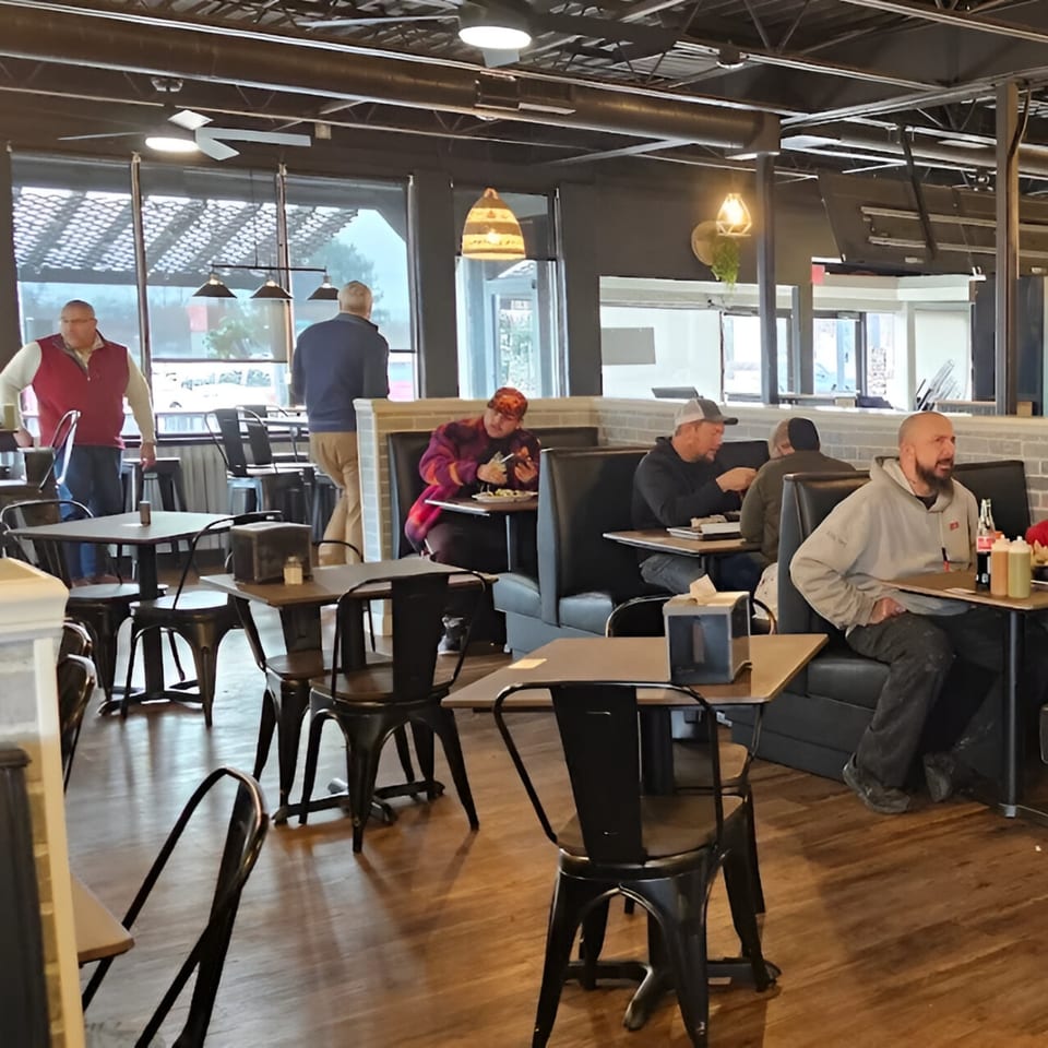 Customers dining in Cabaña Mexican Grill, with some seated at tables and others at booths.